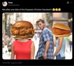 A meme shows a man distracted by a large Popeyes chicken sandwich while holding hands with a smaller sandwich of Chick-fil-a. The scene is humorous and playful.